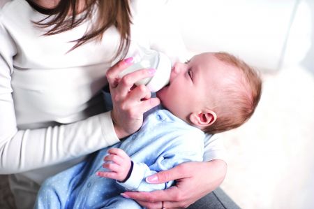 mother bottle-feeding her baby