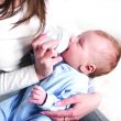 mother bottle-feeding her baby
