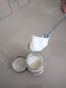 Yogurt and spoon containing milk and lupin yogurt